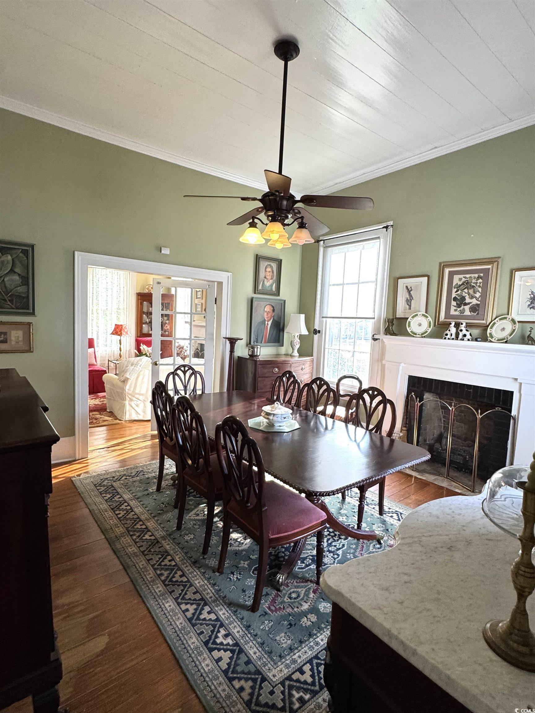 10463 County Line Road Hemingway, SC 29554 - Photo 8 of 40 Dining room with ornamental molding, a tile fireplace, dark wood-style flooring, and a ceiling fan