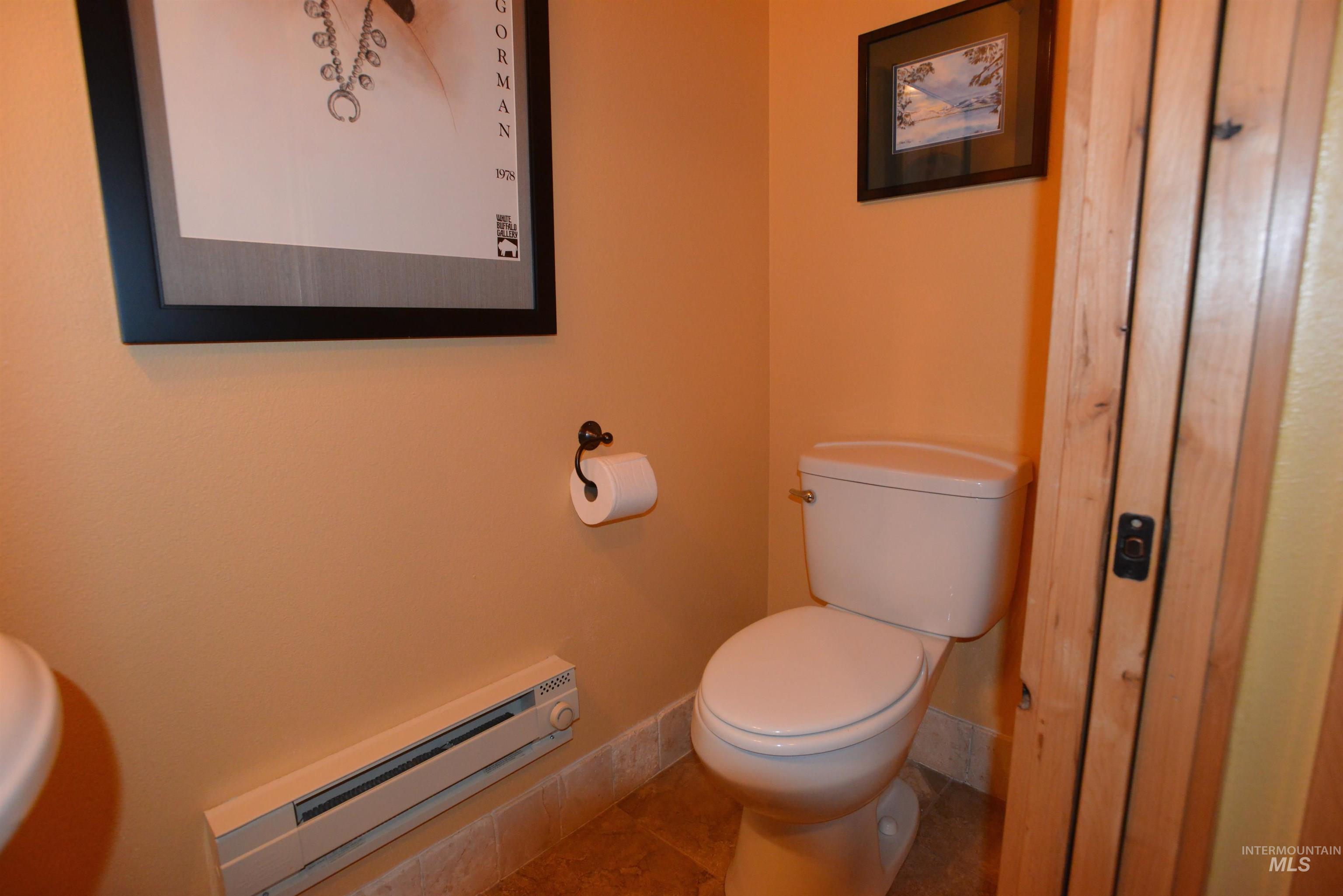 788 Chad Loop McCall, ID 83638 - Photo 9 of 22 Powder room featuring light-toned walls, a white toilet, and wood-finish door