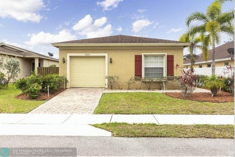 9704 Windrift Circle Fort Pierce, FL 34945 - Photo 1 of 21 a view of a house with a yard