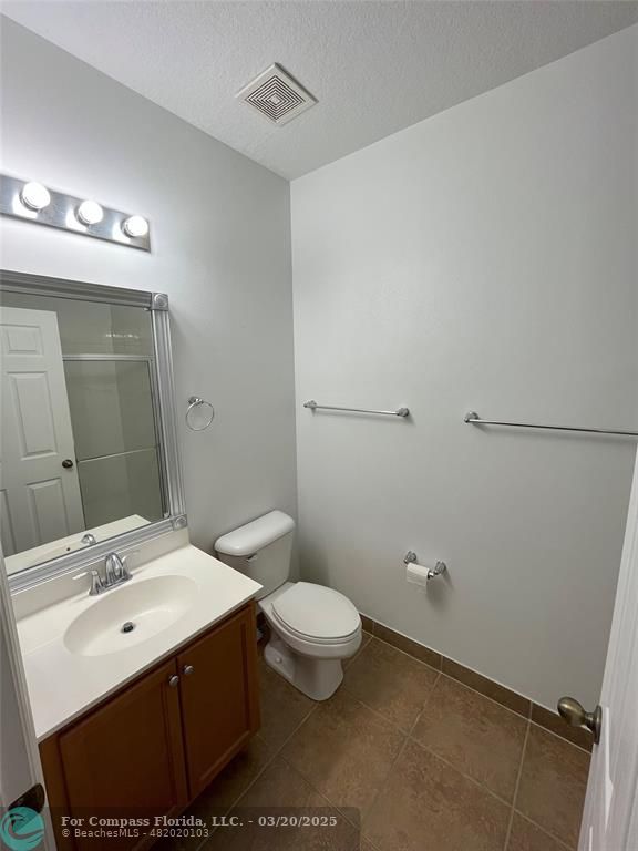 9704 Windrift Circle Fort Pierce, FL 34945 - Photo 11 of 21 a bathroom with a sink a toilet and mirror