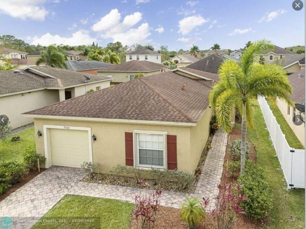 9704 Windrift Circle Fort Pierce, FL 34945 - Photo 2 of 21 a view of a house with a yard