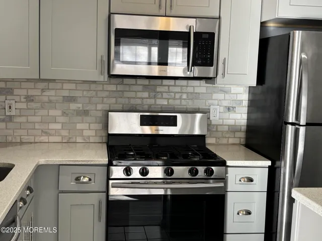 a kitchen with a stove and a microwave