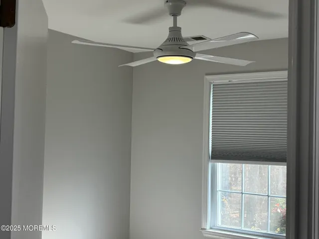 a view of a chandelier fan and window