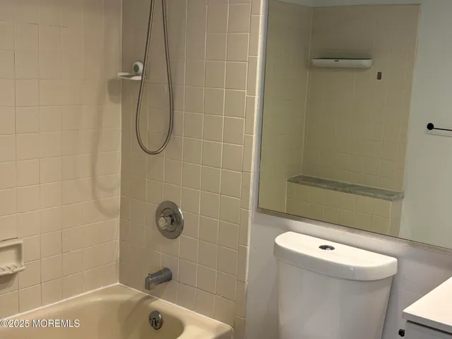 a bathroom with a shower a toilet and a sink