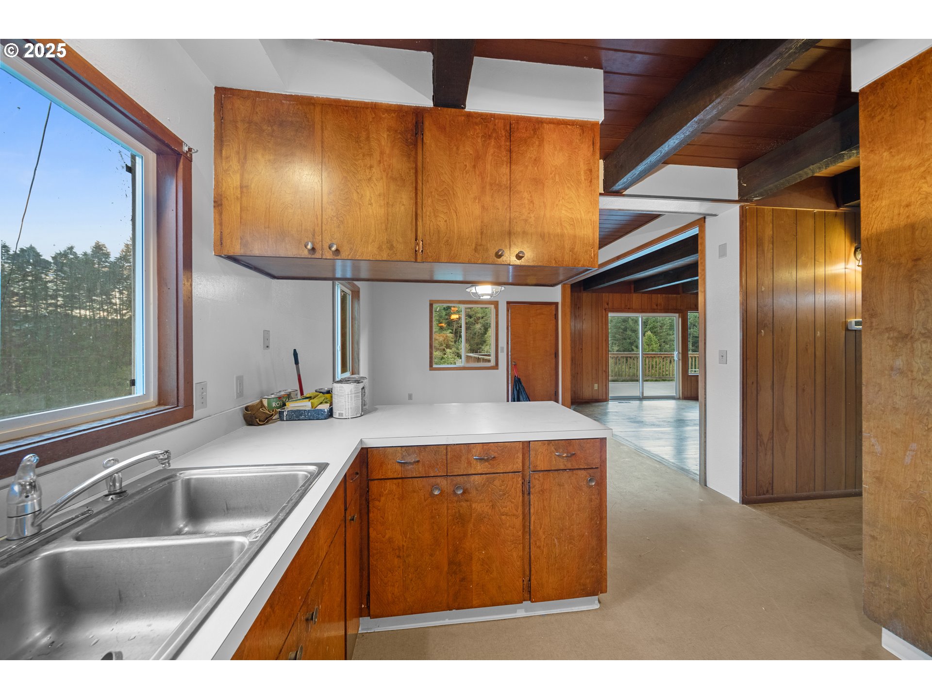 604 Thorton Oar Lane Reedsport, OR 97467 - Photo 12 of 47 a kitchen with kitchen island a counter top space a sink stainless steel appliances and cabinets