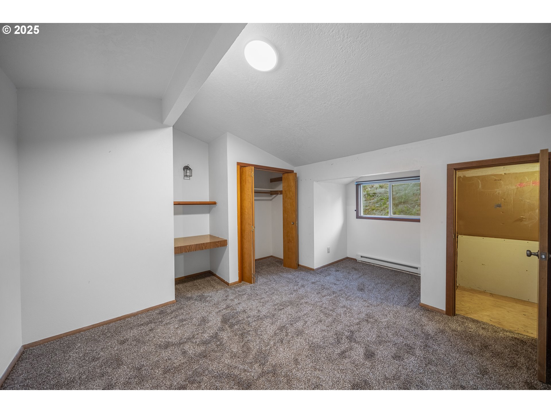 604 Thorton Oar Lane Reedsport, OR 97467 - Photo 15 of 47 a view of an empty room with a window