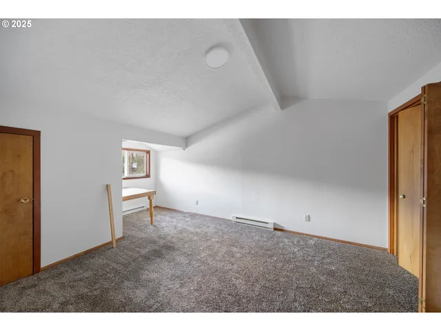 a view of an empty room and a window