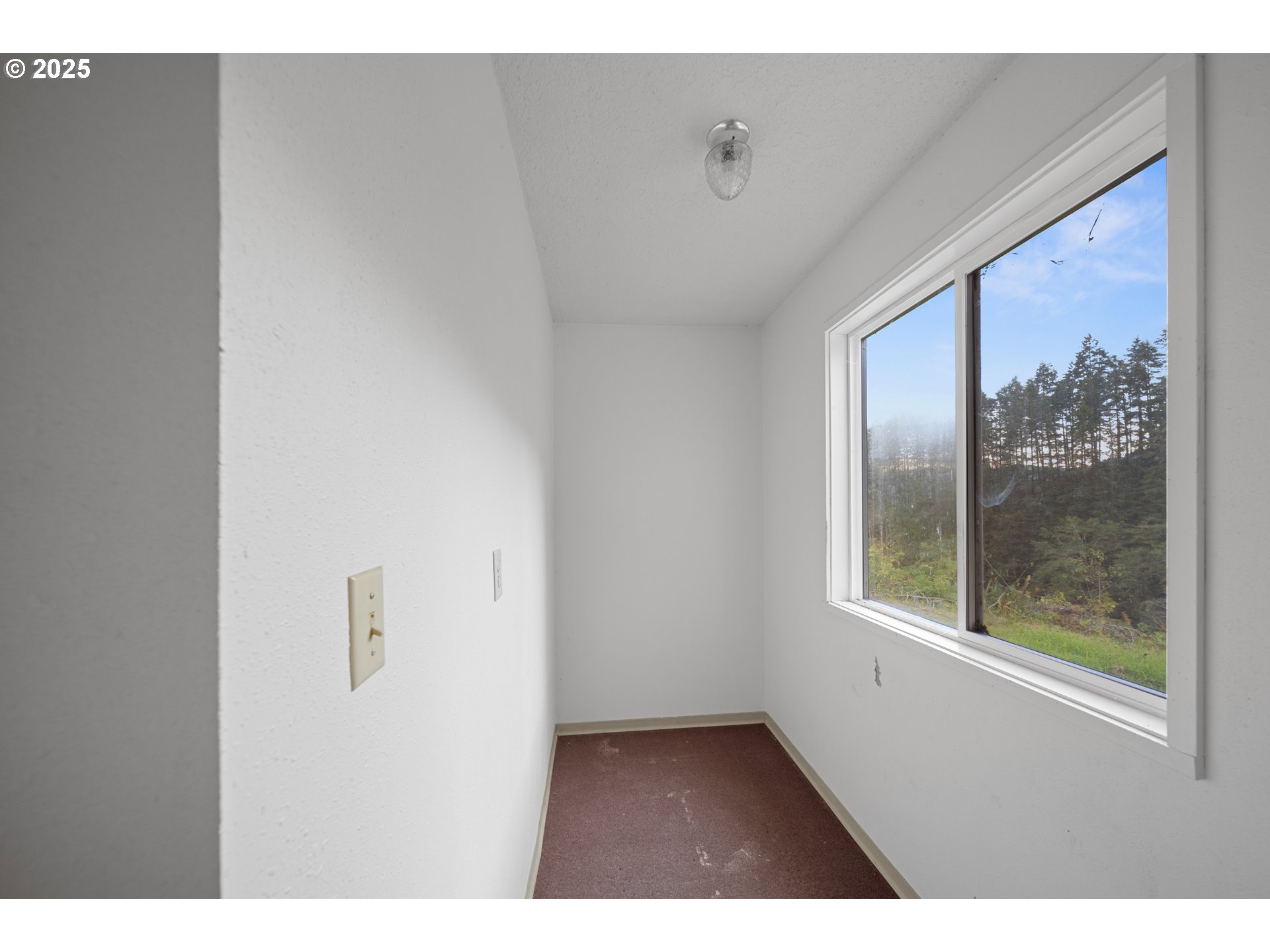 604 Thorton Oar Lane Reedsport, OR 97467 - Photo 25 of 47 a view of an empty room with a window