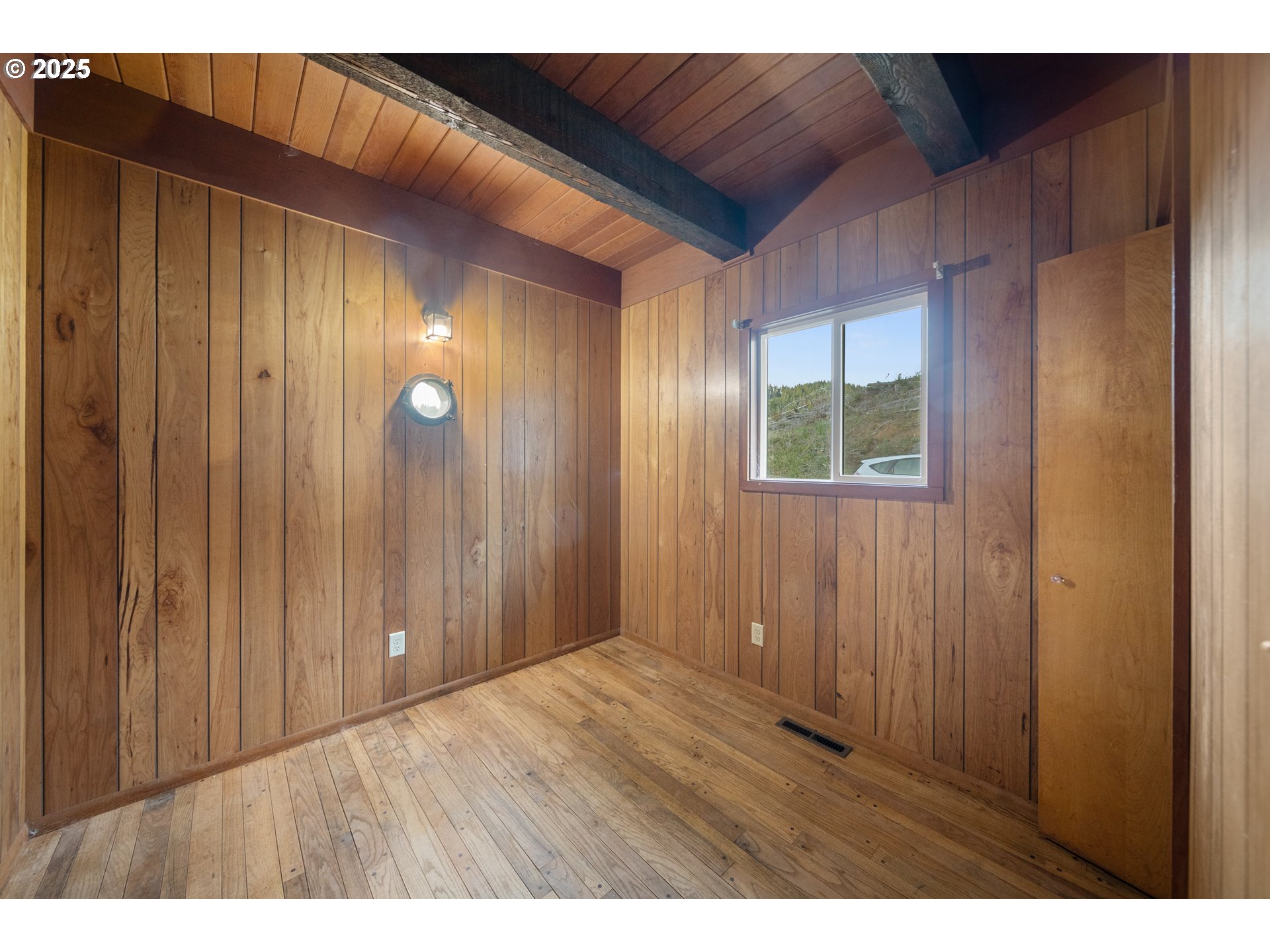 604 Thorton Oar Lane Reedsport, OR 97467 - Photo 27 of 47 a view of an empty room with wooden floor