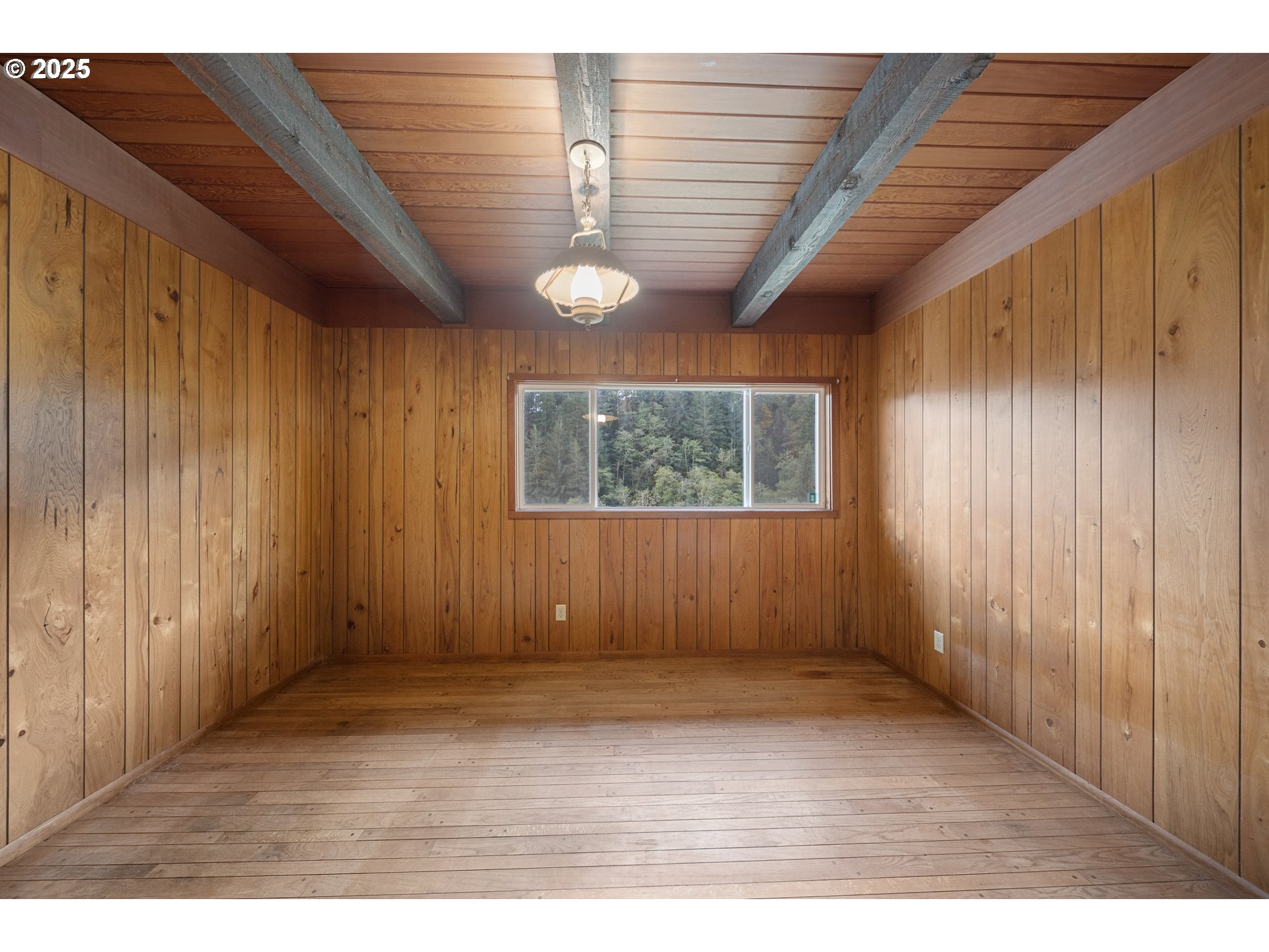 604 Thorton Oar Lane Reedsport, OR 97467 - Photo 29 of 47 an empty room with wooden floor and windows