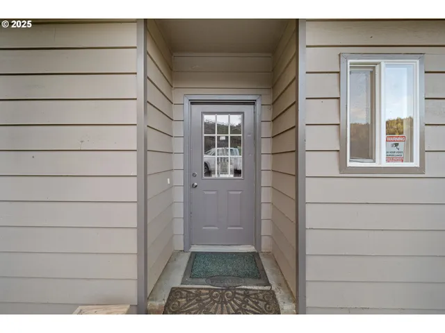a view of a hallway with wooden floor and entryway