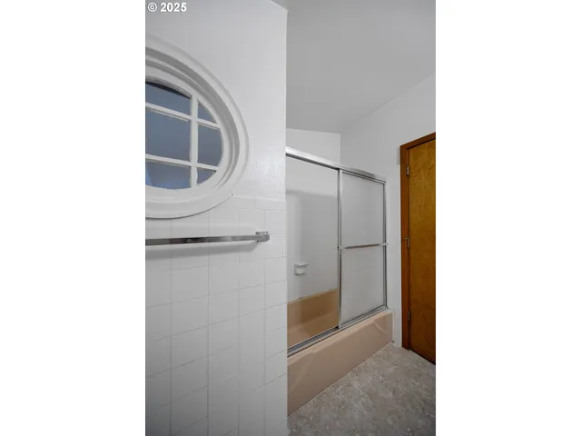 a picture of a bathroom with a shower