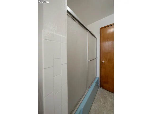 a bathroom with a shower and a mirror
