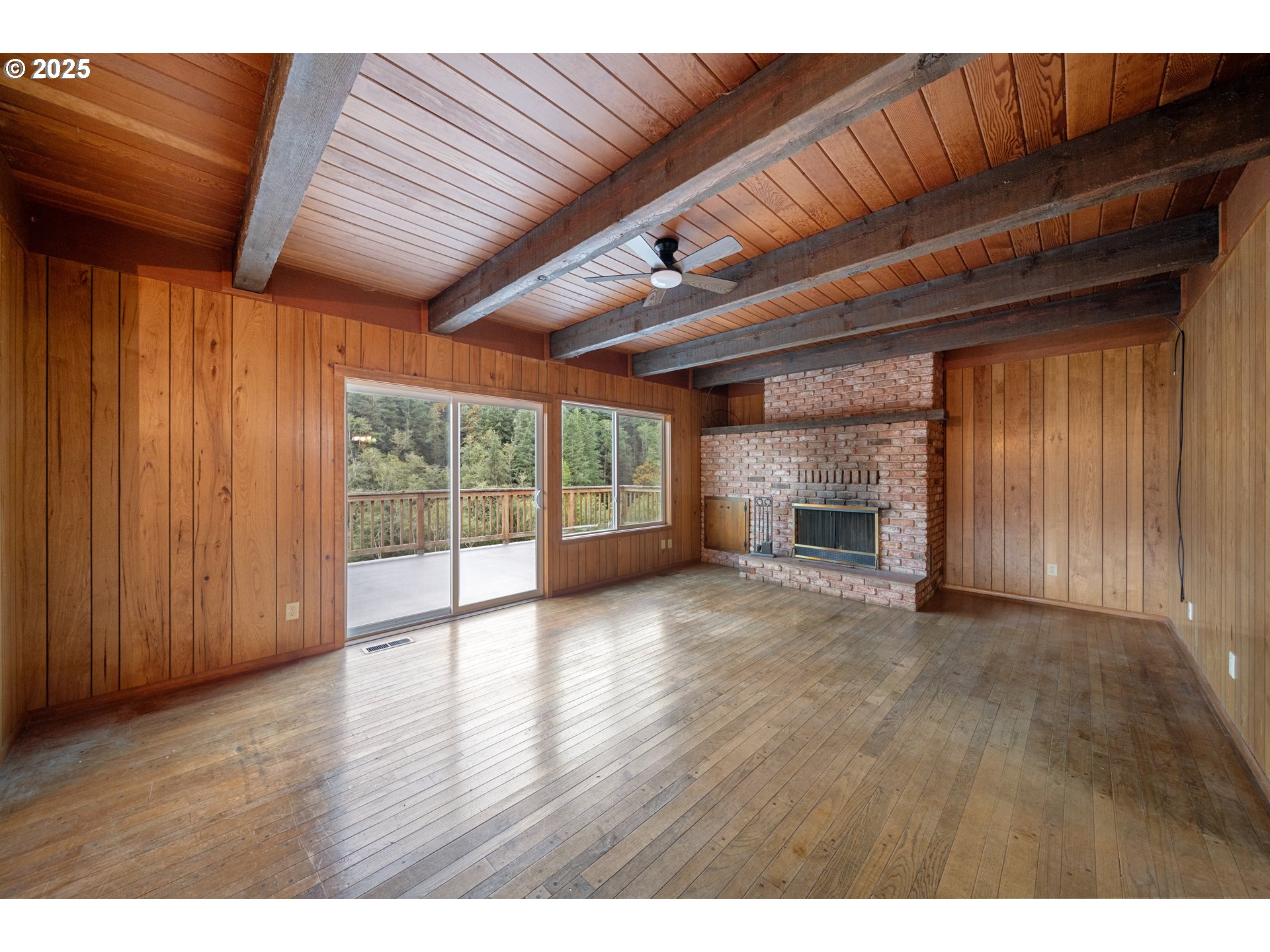604 Thorton Oar Lane Reedsport, OR 97467 - Photo 5 of 47 a view of an empty room with wooden floor and a window