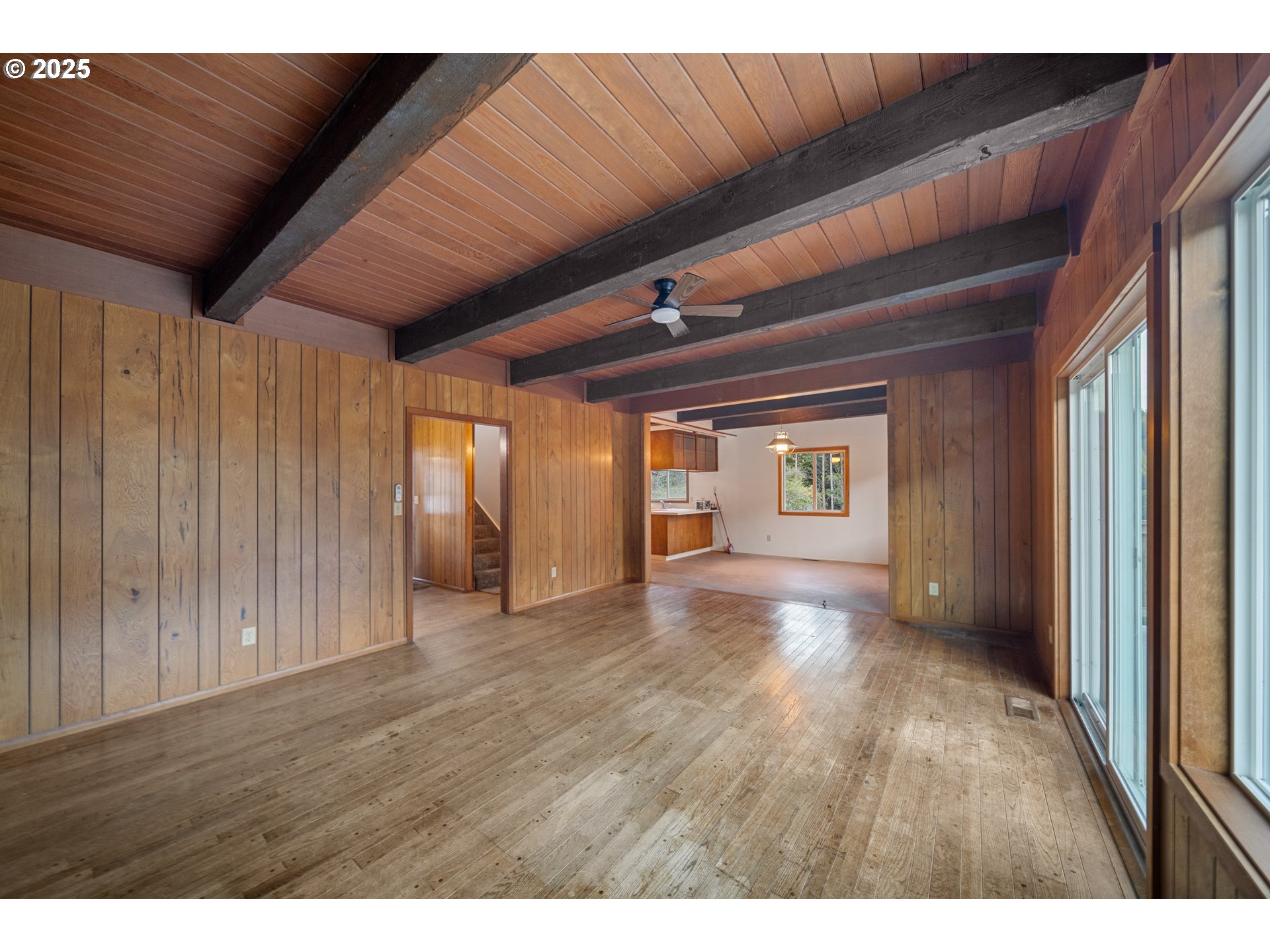 604 Thorton Oar Lane Reedsport, OR 97467 - Photo 6 of 47 a view of an empty room with wooden floor and a window