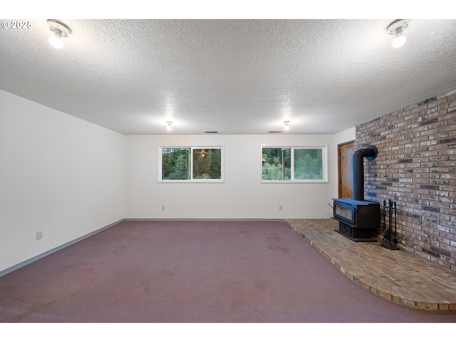 604 Thorton Oar Lane Reedsport, OR 97467 - Photo 7 of 47 a view of empty room with windows