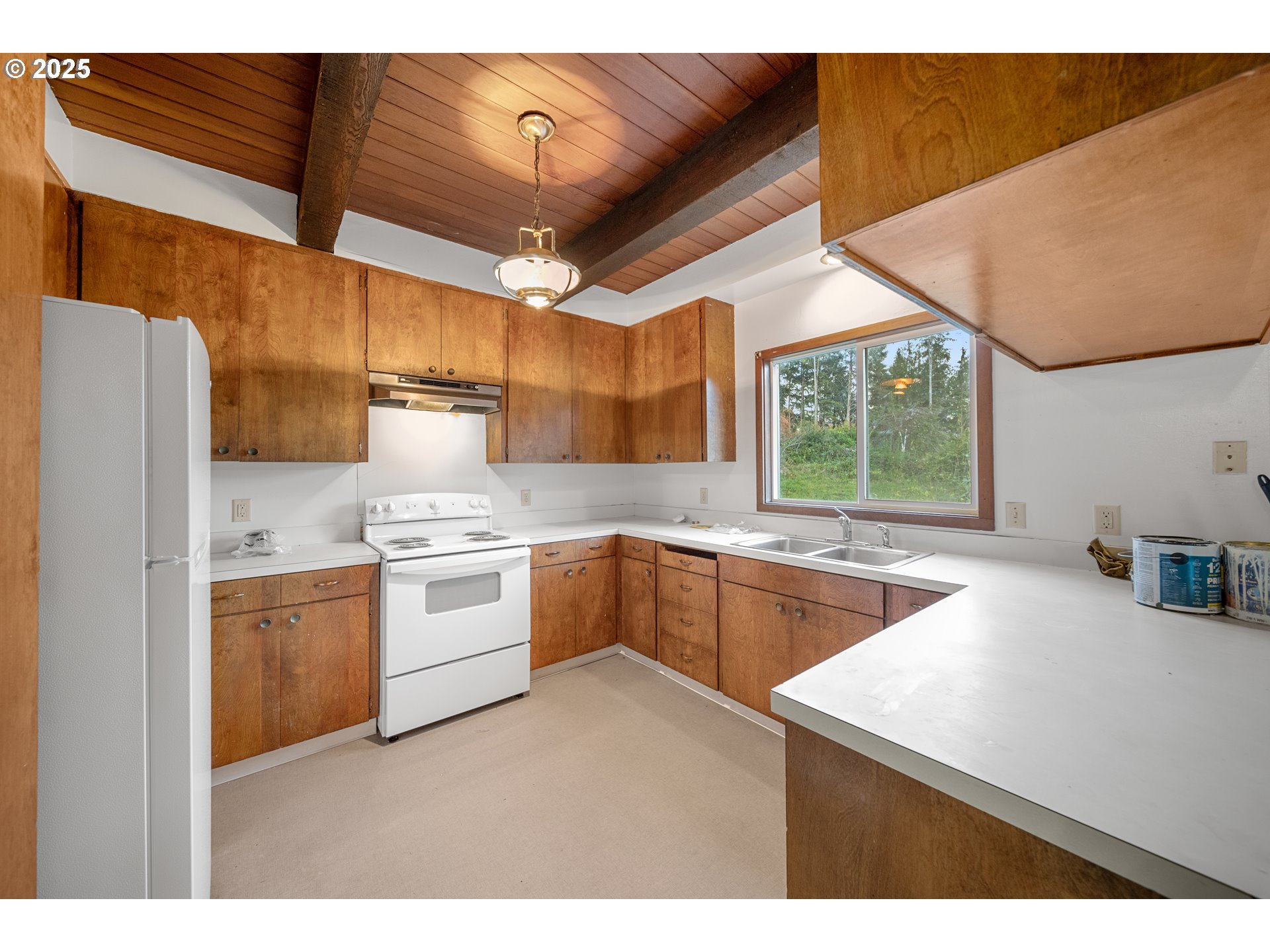 604 Thorton Oar Lane Reedsport, OR 97467 - Photo 9 of 47 a kitchen with a sink cabinets and window