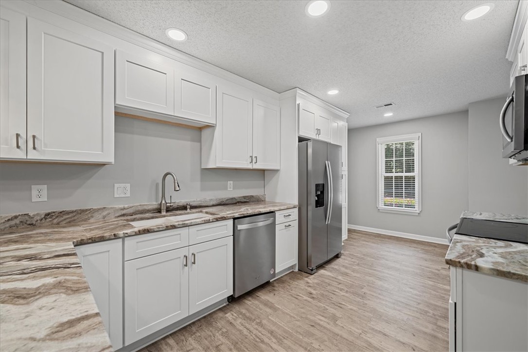212 Blue Ridge Drive Clemson, SC 29631 - Photo 9 of 33 A well-equipped culinary space awaits with pristine white cabinetry and elegant countertops.