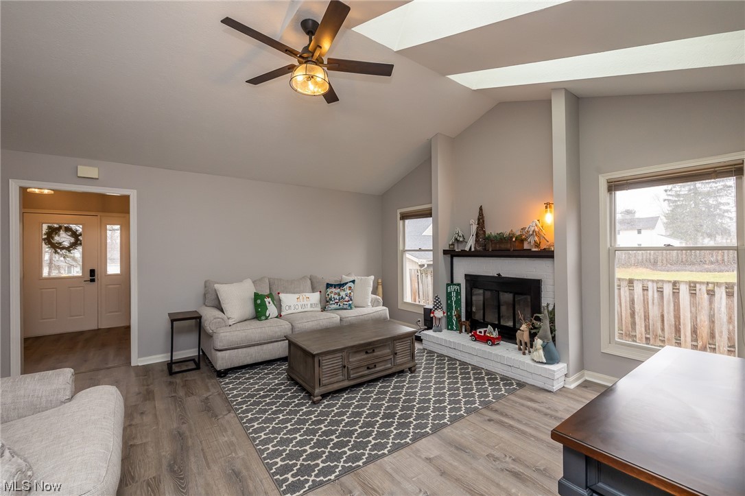 32800 Pettibone Road Solon, OH 44139 - Photo 7 of 49 Living room with lofted ceiling, ceiling fan, a fireplace, and hardwood / wood-style flooring