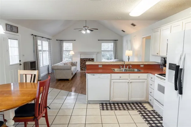 a kitchen with a sink a stove cabinets and counter space