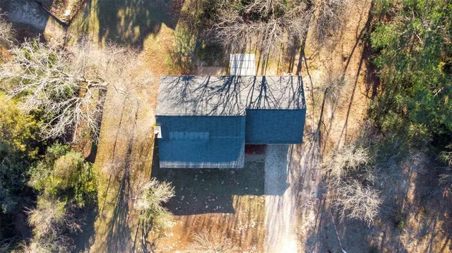 a wooden fence with a house in the background