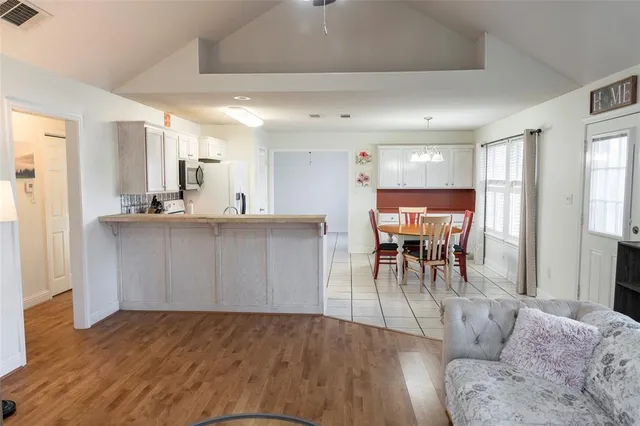 a living room with furniture and kitchen view