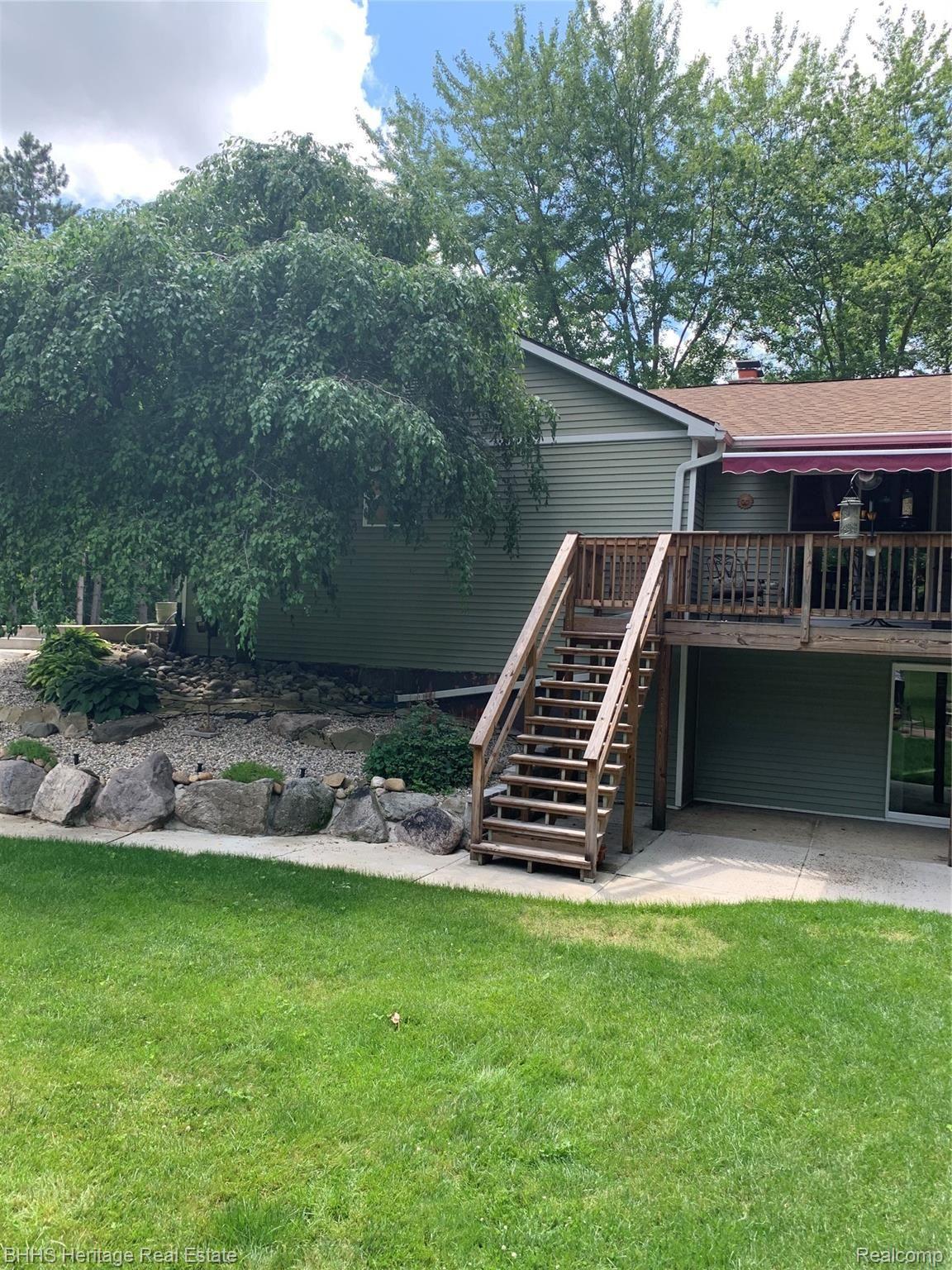 2413 Hunter Road Brighton, MI 48114 - Photo 5 of 42 DECK WITH MOTORIZED AWNING AND STAIRS TO PATIO