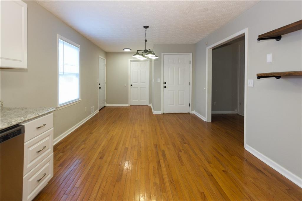 374 McGiboney Road Covington, GA 30016 - Photo 12 of 29 a view of a kitchen with wooden floor and a ceiling fan