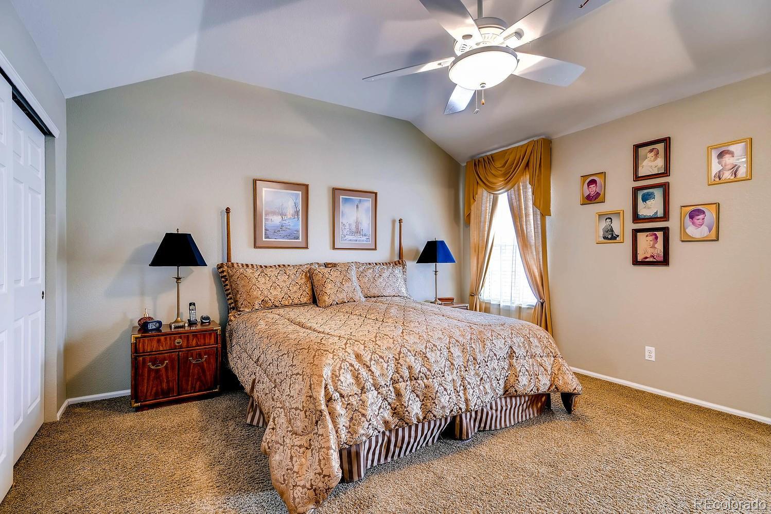 6207 Trailhead Road Highlands Ranch, CO 80130 - Photo 15 of 28 a bedroom with a bed and a chandelier
