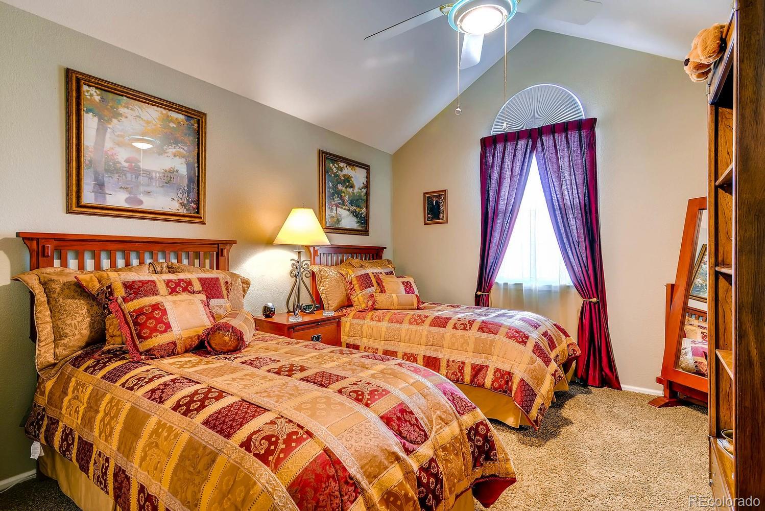 6207 Trailhead Road Highlands Ranch, CO 80130 - Photo 18 of 28 a bedroom with bed and a chandelier