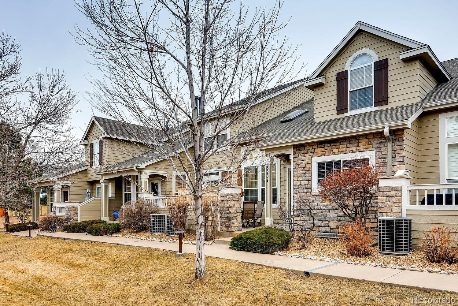 6207 Trailhead Road Highlands Ranch, CO 80130 - Photo 2 of 28 a front view of a house with a yard