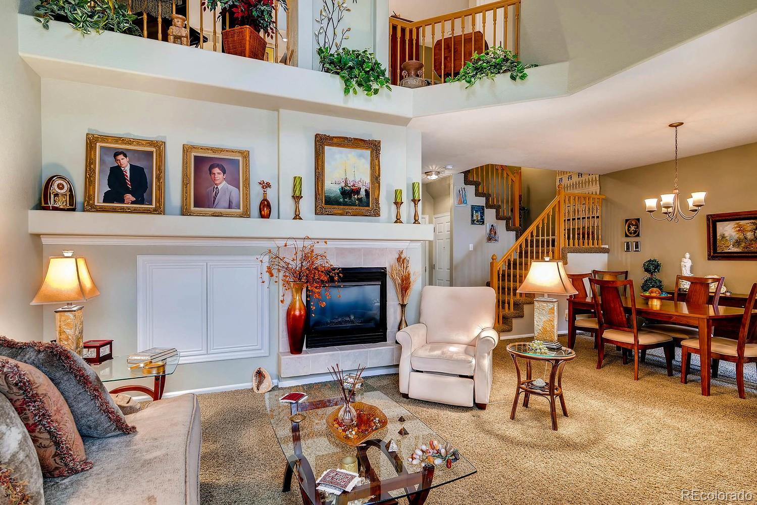6207 Trailhead Road Highlands Ranch, CO 80130 - Photo 5 of 28 a living room with furniture and a fireplace