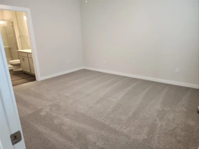 en empty room with windows and fan