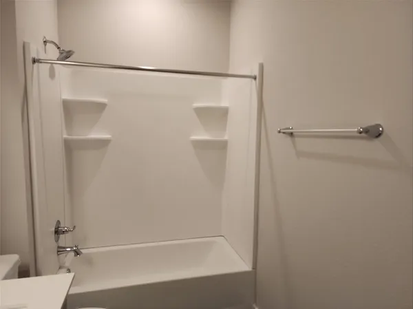 a bathroom with a shower and a bath tub