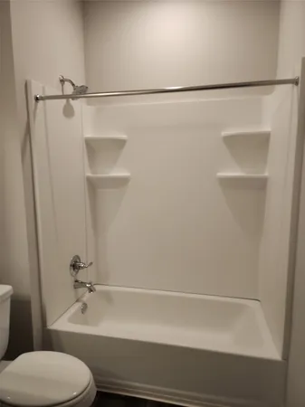 a bathroom with a shower and a toilet