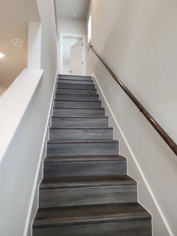 a view of small space with wooden floor and a window