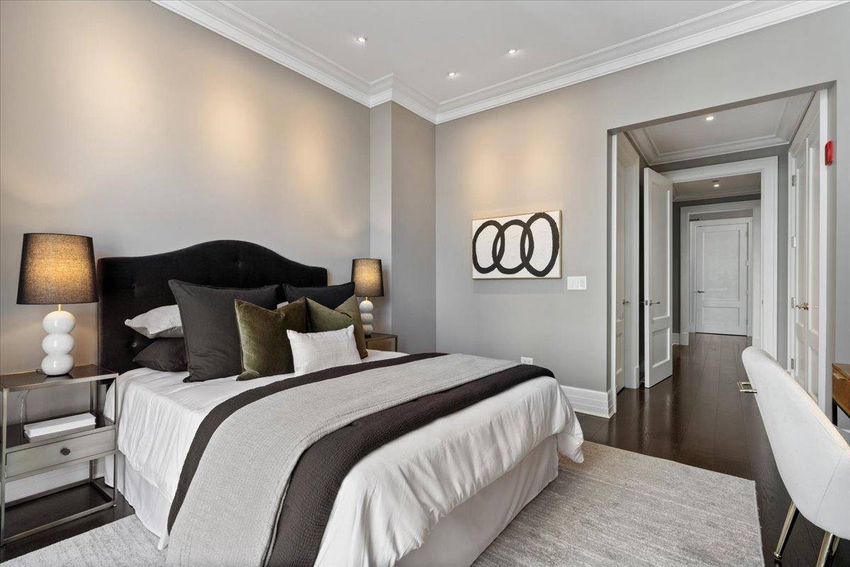 9 West Walton Street, Unit 702 Chicago, IL 60610 - Photo 31 of 38 a bedroom with double bed and a lamp
