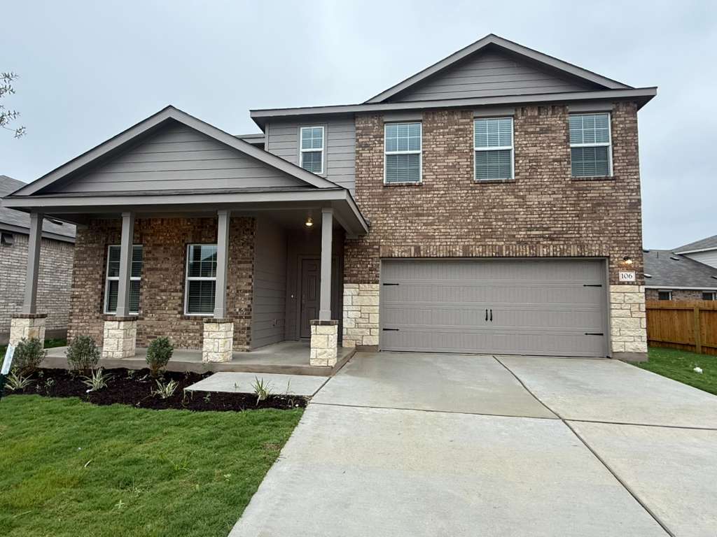 106 Brabham Loop Hutto, TX 78634 - Photo 3 of 40 Two-story residence featuring a brick and siding exterior, stone accents, an integrated two-car garage, and a covered front porch with column supports