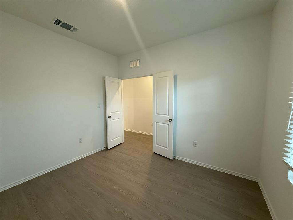 106 Brabham Loop Hutto, TX 78634 - Photo 9 of 40 Room featuring light wood-finish flooring and white walls