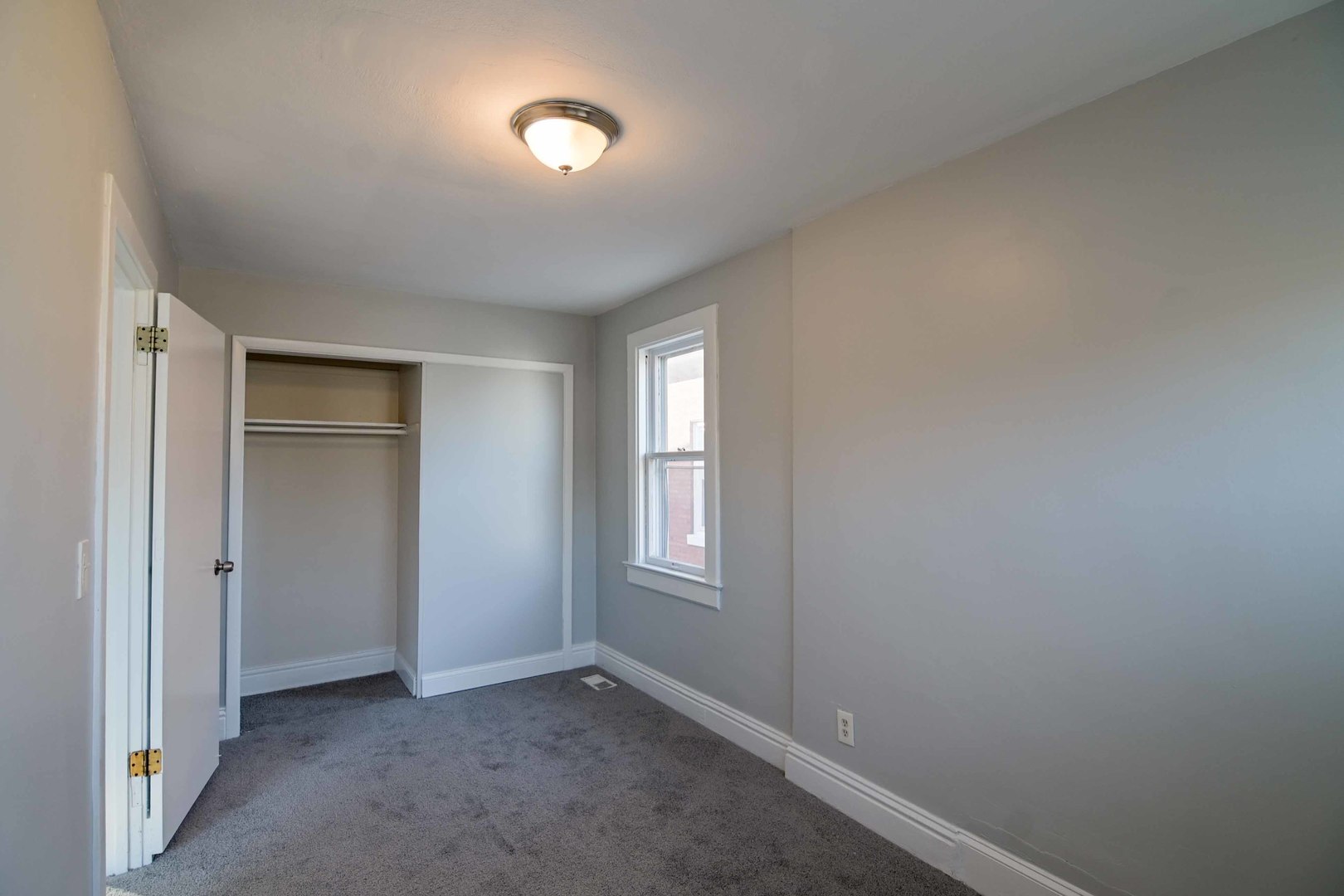 817 11th Street North Chicago, IL 60064 - Photo 14 of 45 an empty room with windows and closet