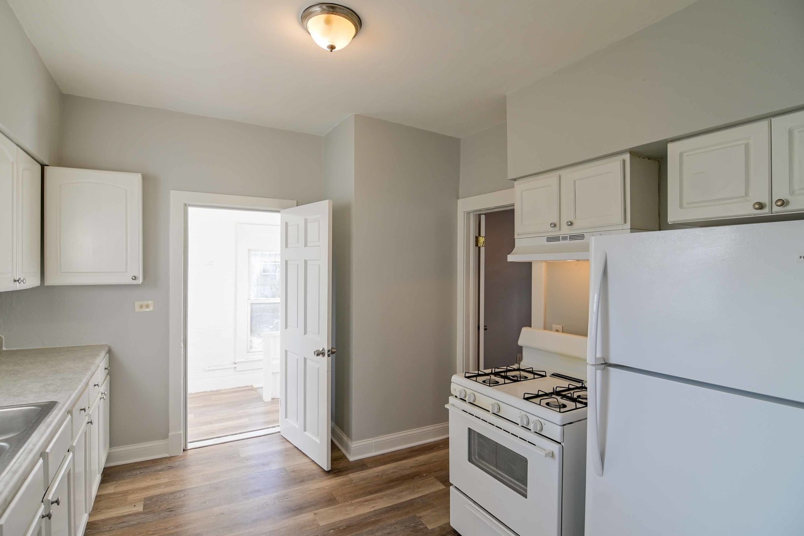 817 11th Street North Chicago, IL 60064 - Photo 23 of 45 a kitchen with a stove and a refrigerator