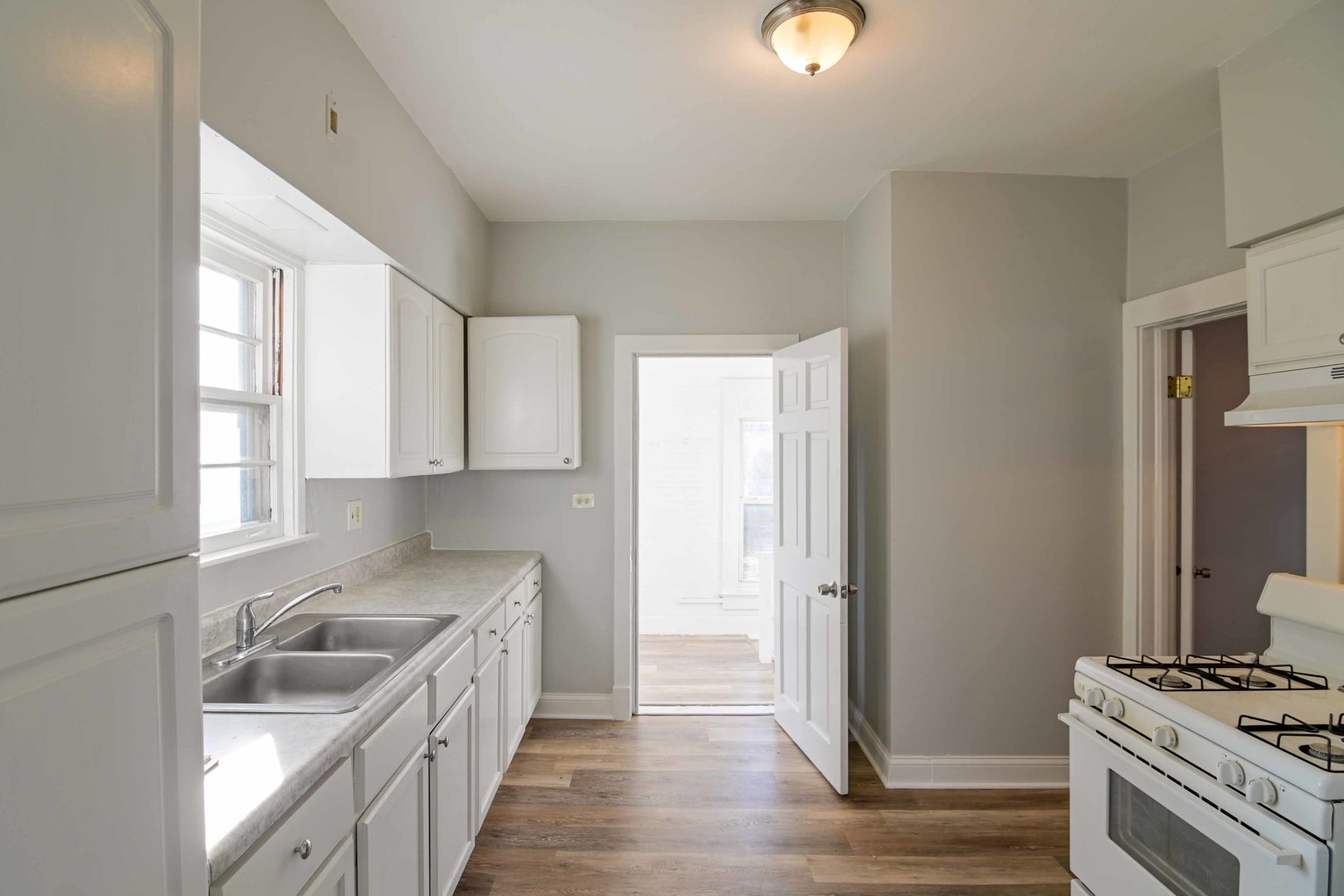 817 11th Street North Chicago, IL 60064 - Photo 24 of 45 a kitchen with stainless steel appliances granite countertop a sink stove and refrigerator