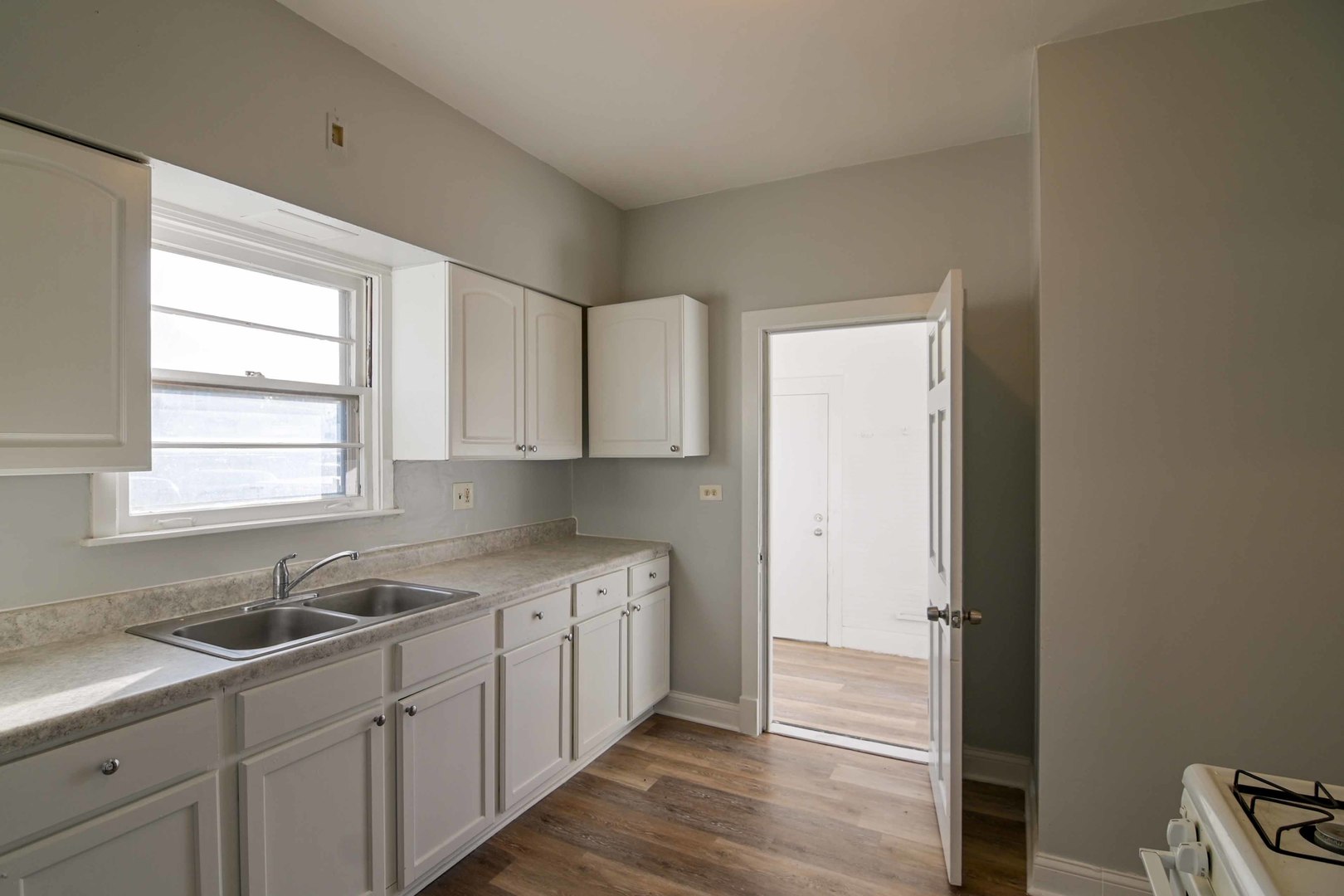 817 11th Street North Chicago, IL 60064 - Photo 25 of 45 a kitchen with a sink cabinets appliances and a window