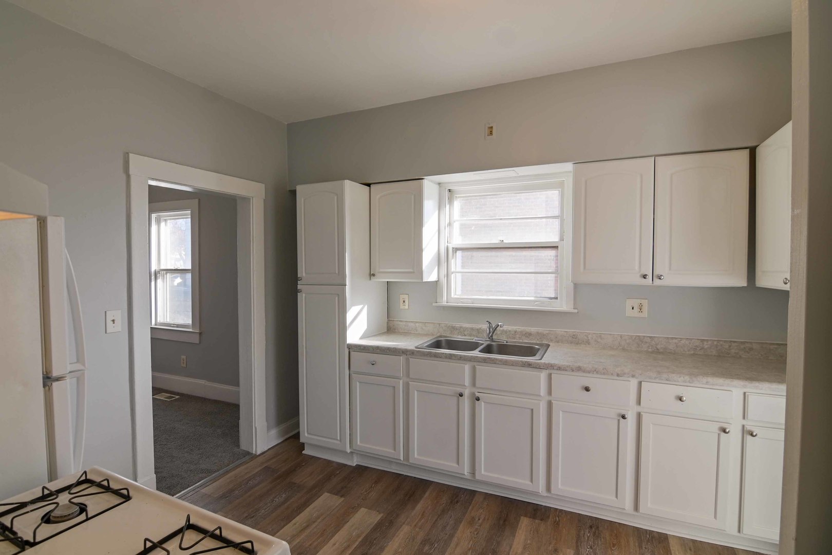 817 11th Street North Chicago, IL 60064 - Photo 26 of 45 a kitchen with sink cabinets and wooden floor