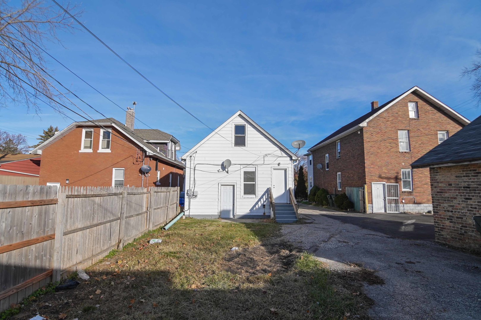 817 11th Street North Chicago, IL 60064 - Photo 40 of 45 a view of a house with a small yard and wooden fence