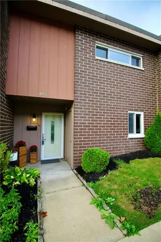 a view of a house with potted plants