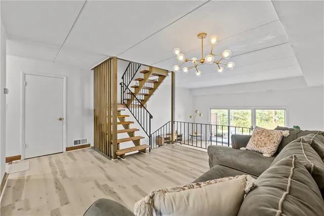 a living room with furniture and a chandelier