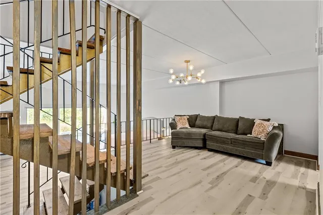 a living room with furniture and a chandelier