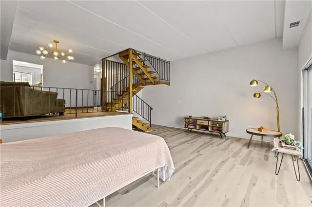 a spacious bedroom with a bed a table and chair