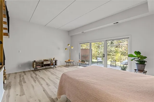 a bedroom with a bed and a large window